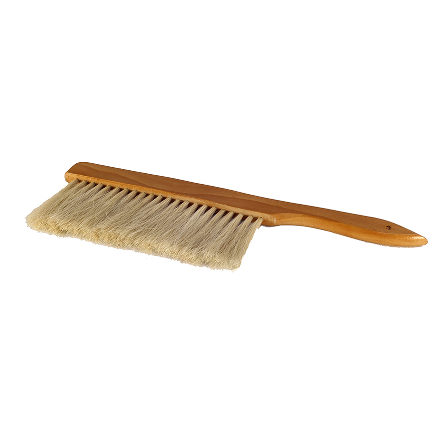 A natural horse hair bristled bee brush with a wooden handle. Wells